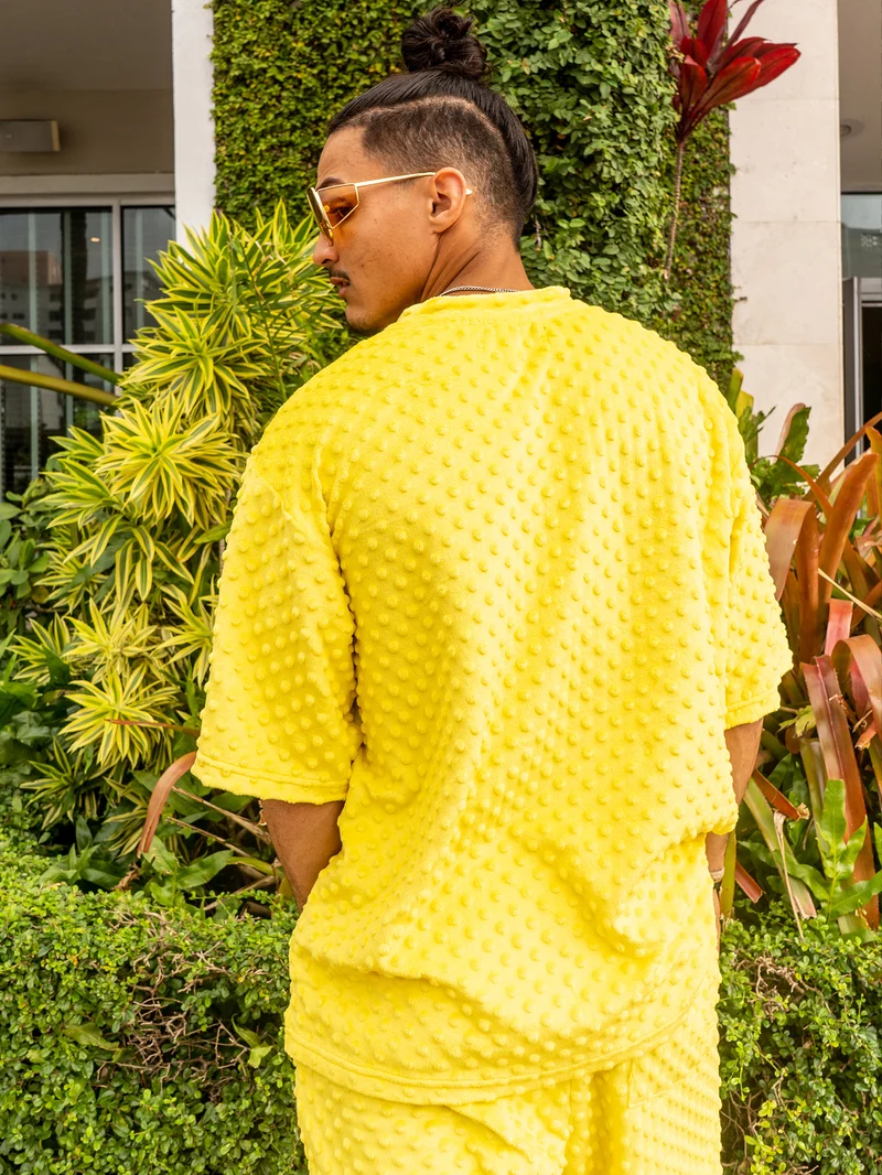 Back view of a man in a yellow textured set