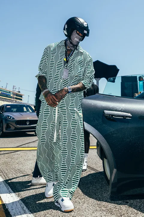 Miles Chamley-Watson in printed linen beside a car at the Miami E-Prix
