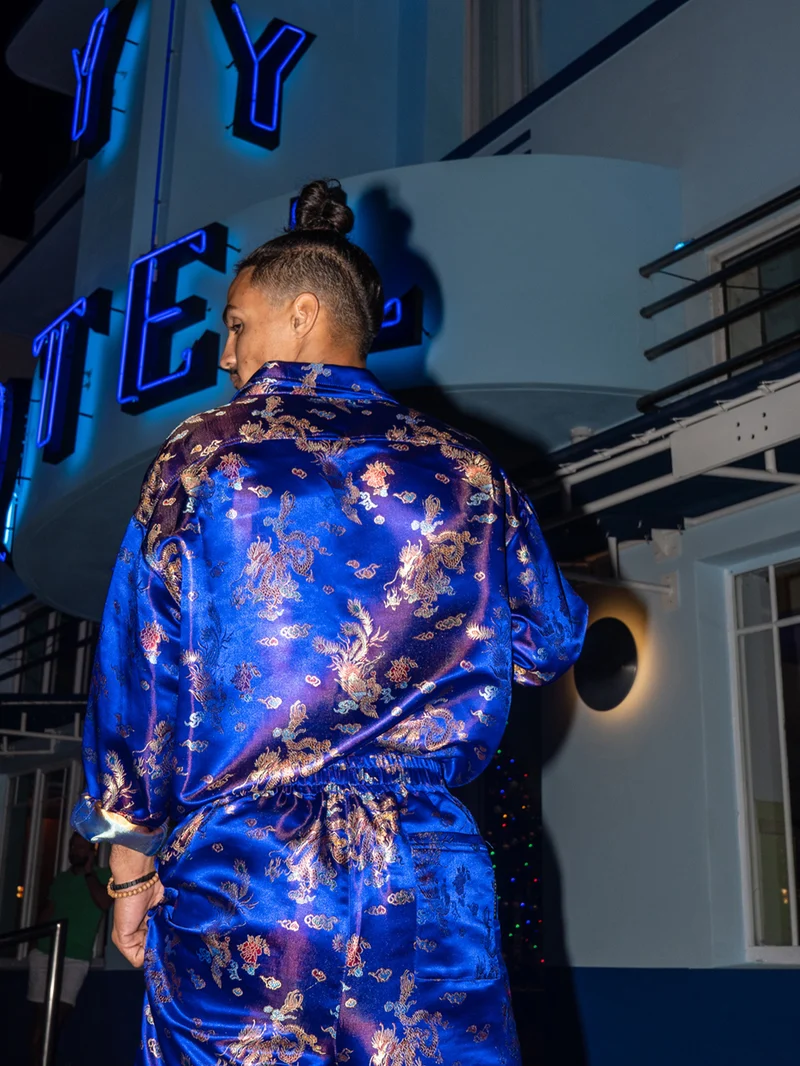 Back view of a model in a cobalt dragon brocade set