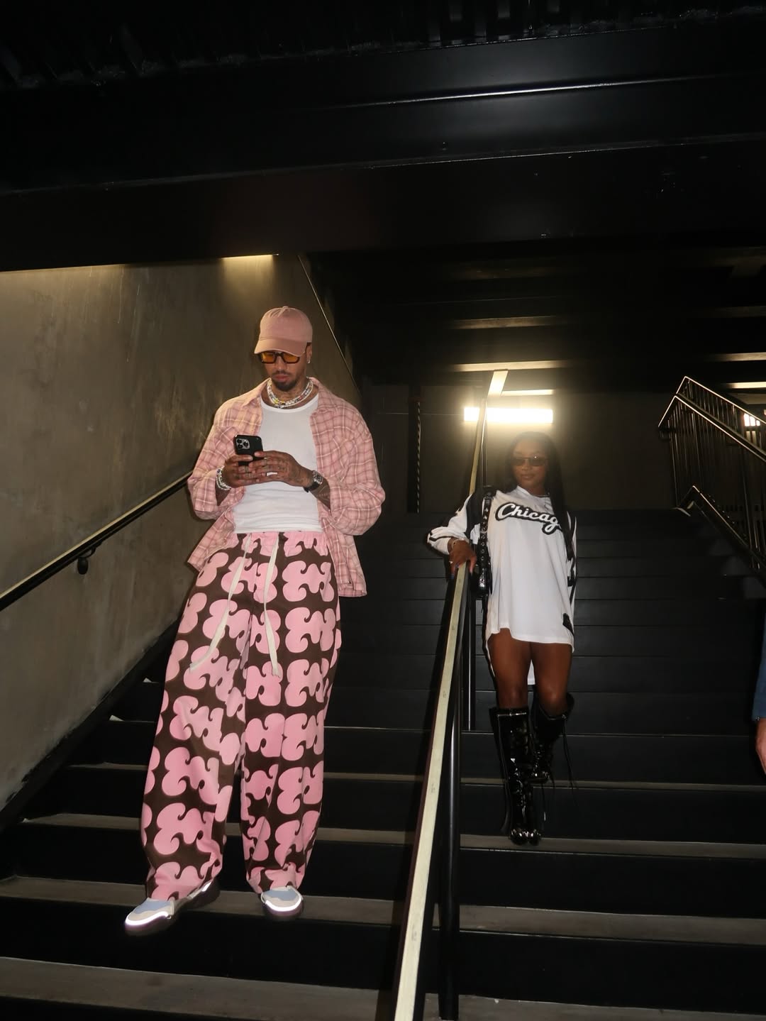 Miles Chamley-Watson and Simone Biles together on the stairs at the Bears–Raiders game
