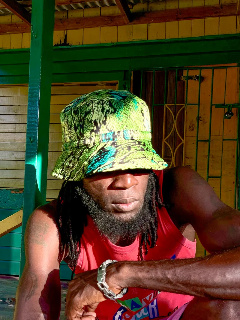 Front portrait of a model in a snakeskin-print bucket hat