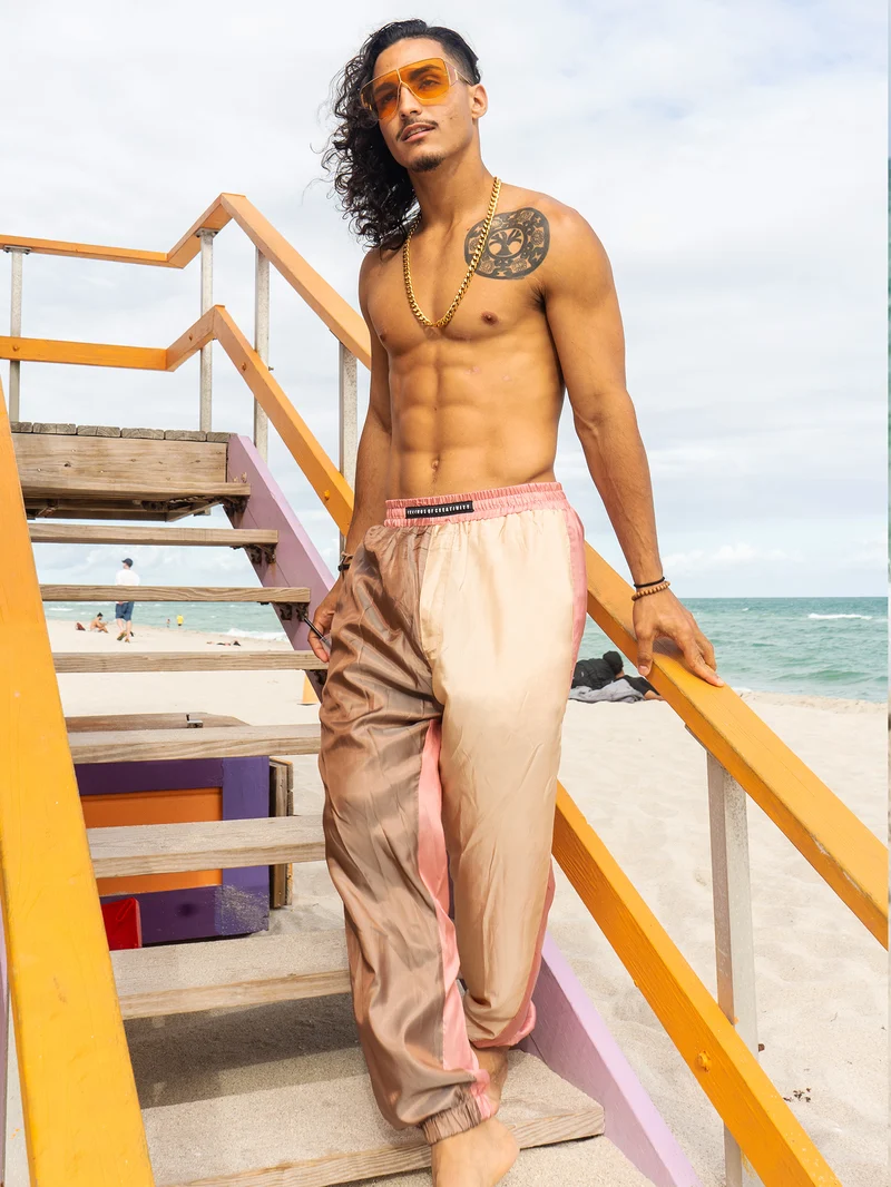 Model in colorblock satin trousers on lifeguard stand stairs