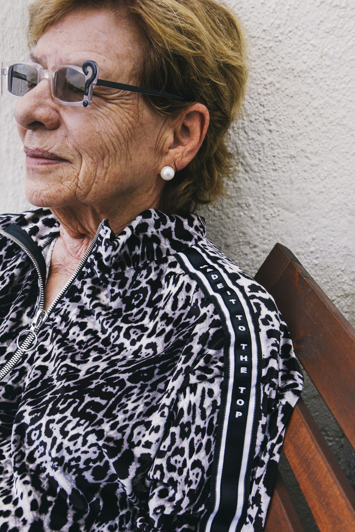 Portrait of a model in a black-and-white patterned LOC top and sunglasses