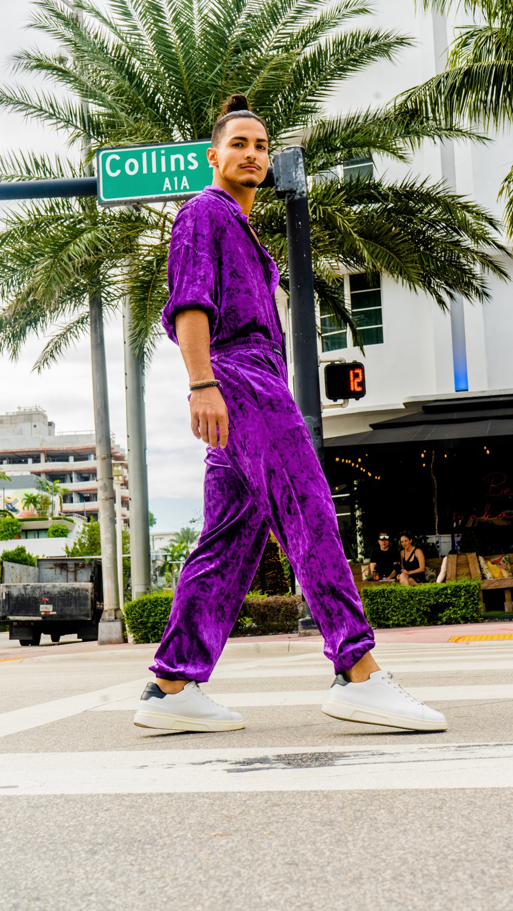 Full-length Miami portrait in purple velvet with elastic cuffs and shoes visible