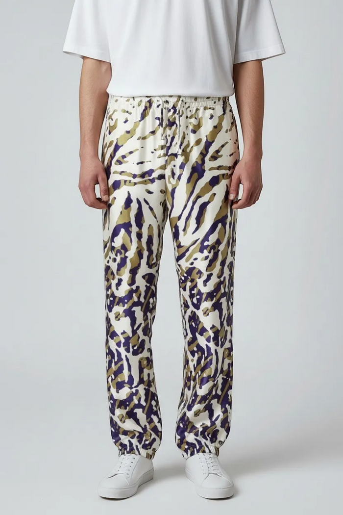 Legends of Creativity James Abstract Animal Track Pant in cream with purple and gold abstract animal print, silk, elastic waistband, and cuffs.